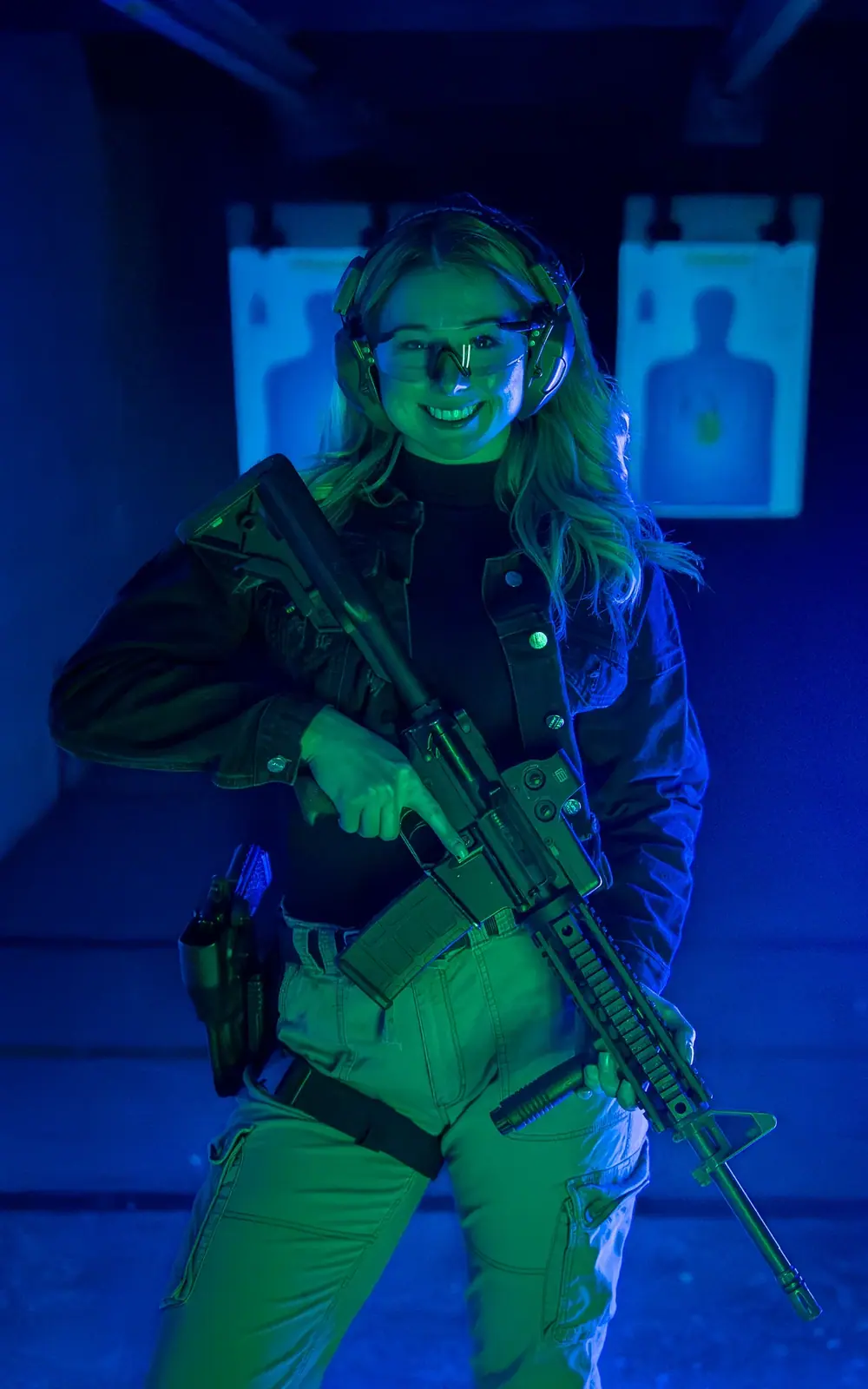 Indoor shooting range photographed under blue lighting for a firearms brand
